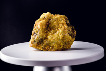 uranium ore, on electronic scale. Metal used in industry. Mineral extraction concept.