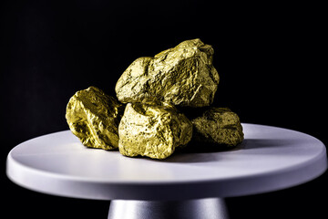 gold stone on electronic scale. Metal used in industry. Mineral extraction concept.