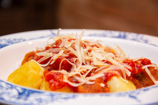 Gnocchi. Roasted Italian pasta with tomato sauce, parmesan cheese and meatballs.