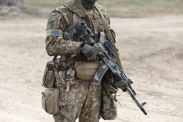 Soldier with machine gun and flag of Democratic Republic of the Congo on military uniform. Collage.