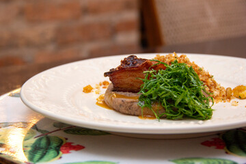 Fried bean with crunchy bacon, ground banana and cabbage