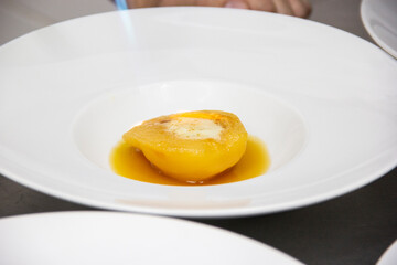 Preparing dessert of pear brulee with dolce gorgonzola cheese