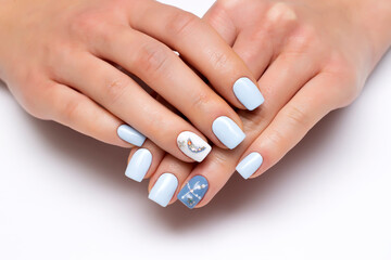 Obraz na płótnie Canvas White, light blue, manicure with the moon, with stones, crystals, rhinestones dots on short square nails close-up on a white background.