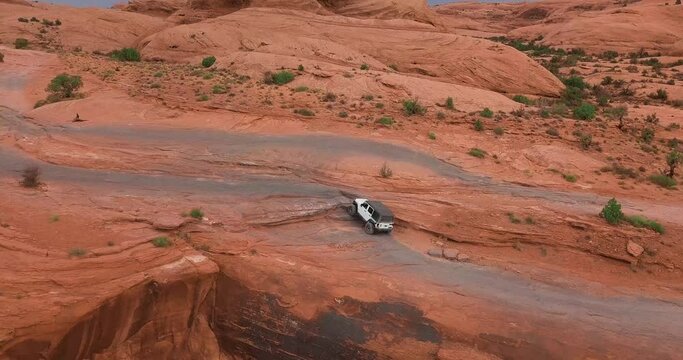 Off-roading Vehicle Driving in the Beautiful Deserts by a Steep Cliff Trail