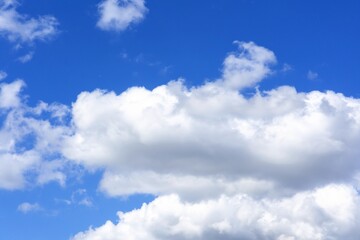 Obraz na płótnie Canvas beautiful fluffy clouds on a bright blue summer sky