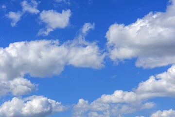 beautiful fluffy clouds on a bright blue summer sky
