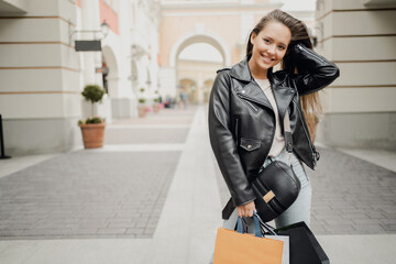 portrait of a Thrifty confident brunette woman of European appearance holding bags with gifts for the family