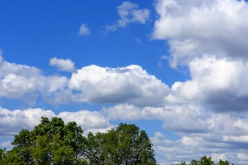 white cumulus clouds against a bright blue sky