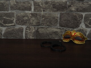Waiting. Handcuffs and mask on the table.