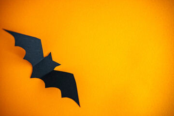 Holidays concept - Halloween paper decorations and sweets with blank copy space over orange background. Flat lay of accessory decoration