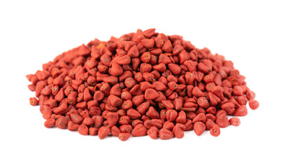 Annatto seeds, isolated on white background. Achiote seeds, bixa orellana. Natural dye for cooking and food. Close-up.