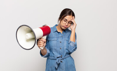 young hispanic woman feeling bored, frustrated and sleepy after a tiresome, dull and tedious task,...