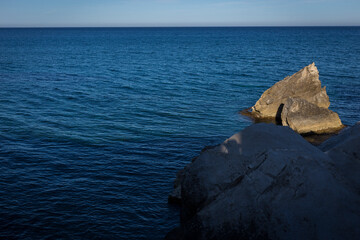 Horizontal rocky seascape of blue ocean water until the horizon of the Alboran Sea, Andalusia's largest coastal protected area, Cabo de Gata-N&iacute;jar Natural Park in the southeastern corner of Spain