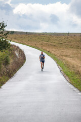 young man running on country road
