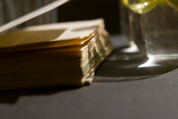 glass with water and a book in the sun