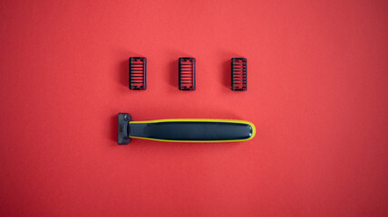 Beard trimmer with three attachments on the red background. 