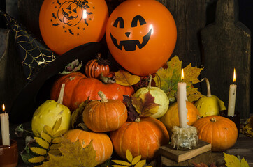 Halloween composition, pumpkins and balloons on a black background. Halloween home decoration