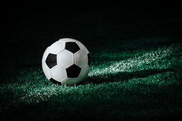 traditional soccer ball on soccer field. Vintage color filter