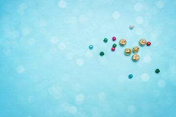 Christmas bells on blue background with shiny bokeh, magician celebration time