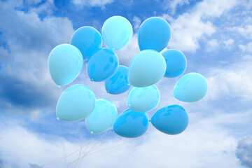 blue ballons on a sky with clouds