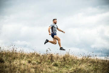 handsome trail runner running in nature