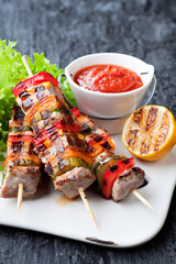 Grilled meat with vegetables on skewers, selective focus