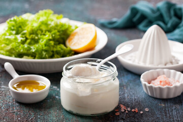 Homemade mayonnaise sauce in a glass jar, selective focus