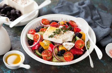 Greek salad with fresh vegetables, feta cheese and dried black olives, selective focus