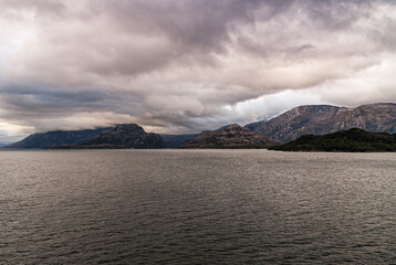 Sarmiento Channel, Chile - December 11, 2008: Amalia Glacier and Fjord. Thick brown cloudscape...