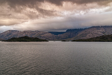 Sarmiento Channel, Chile - December 11, 2008: Amalia Glacier and Fjord. Thick brown cloudscape...