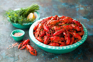 Boiled red crayfish with dill in a bowl on the table, selective focus