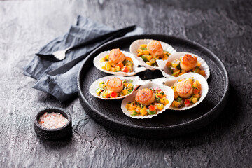 Grilled scallops shell with peach salsa, selective focus