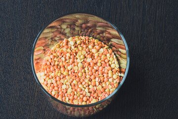 Glass pot  full of red and yellow lentils