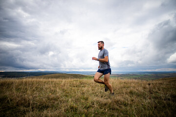 Fototapeta premium handsome trail runner running in nature