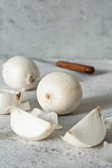 Organic sweet white onion on a gray background with hard shadows, farm harvest, healthy vegetable.