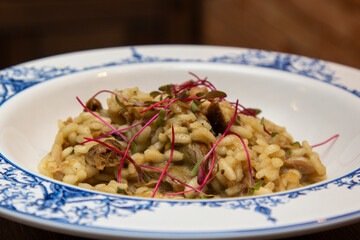 Risotto of vitello with funghi porcini sauce and micro-leaf of beet