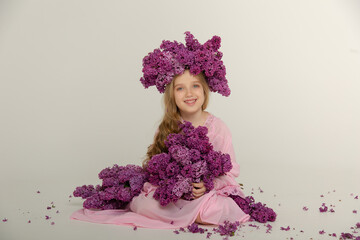 Fototapeta premium Little cute bright girl in the studio with lilac