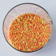 Glass pot  full of red and yellow lentils