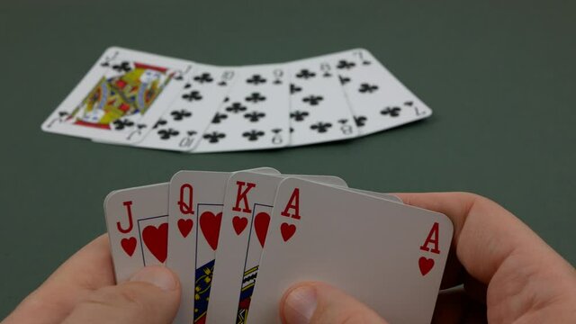 Poker player revealing Royal Flush Hearts, Gambler with winning hand