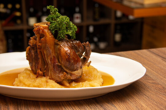 Stinco pork with green apple puree. Traditional Eisbein