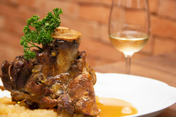 Stinco pork with green apple puree. Traditional Eisbein. harmonized with sparkling wine