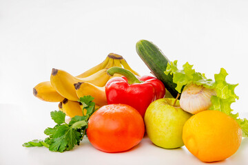 Fototapeta na wymiar fresh fruits and vegetables on a white background, apples, tomatoes, lemon, garlic, cucumber, pepper, bananas, lettuce