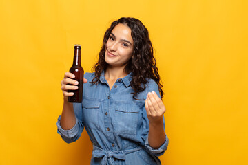 young hispanic woman making capice or money gesture, telling you to pay your debts!