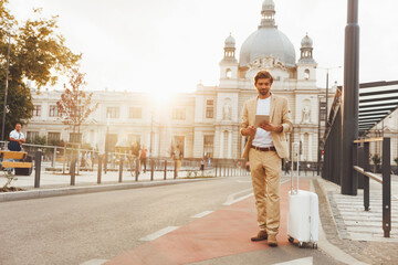 Man in suit using tablet for checking schedule of bus