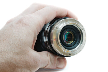 photography lens in hand close up, bayonet mount isolated on white background