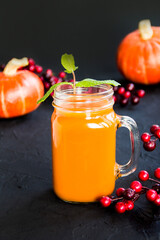 Halloween cocktail, pumpkin orange drink with spices. Dark vintage dirty background. Creative atmospheric decoration