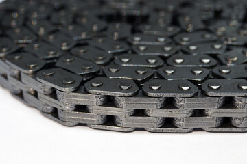 Timing chain of an engine of a modern car. Macro photography. Individual links of the chain are in focus, the background is blurred.