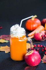 Halloween cocktail, pumpkin orange drink with spices. Dark vintage dirty background. Creative atmospheric decoration