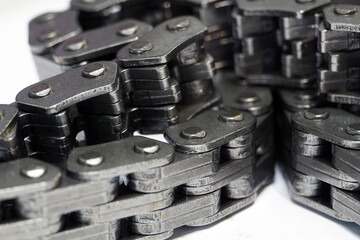 Timing chain of an engine of a modern car. Macro photography. Individual links of the chain are in focus, the background is blurred.