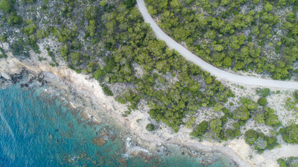 Aerial drone top down photo of road and tropical seascape and rocky beach with turquoise clear...